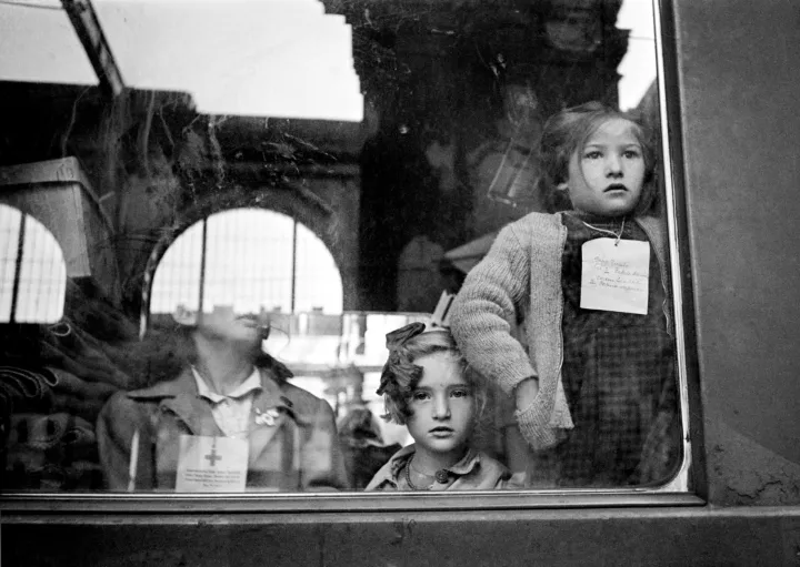 HUNGARY. Budapest. 1947. Keleti train station. Children are sent to Switzerland for three months, each with a tag around the neck indicating name and belongings. © Werner Bischof HUNGARY. Budapest. 1947. Keleti train station. Children are sent to Switzerland for three months, each with a tag around the neck indicating name and belongings. The ‘Children’s train’ leaves Switzerland about once every three months, traveling to Budapest via Vienna. Passing through these capital cities, the train delivers the most urgently needed provisions and then, on the return trip, takes on about 50 weary children from each city for three months of recuperative vacation.